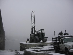 Drilling to assess soil characteristics preliminary to foundation design.