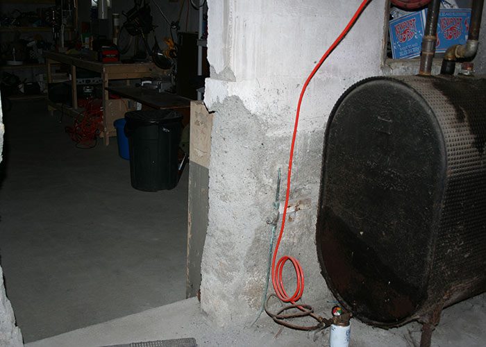 Deteriorated concrete foundation due to use of beach sand